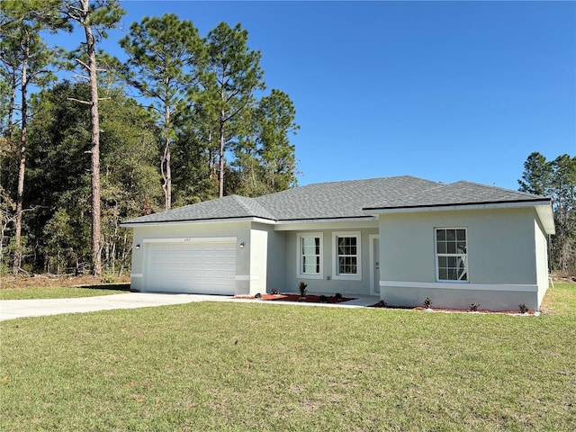 view of front of house with a garage and a front lawn