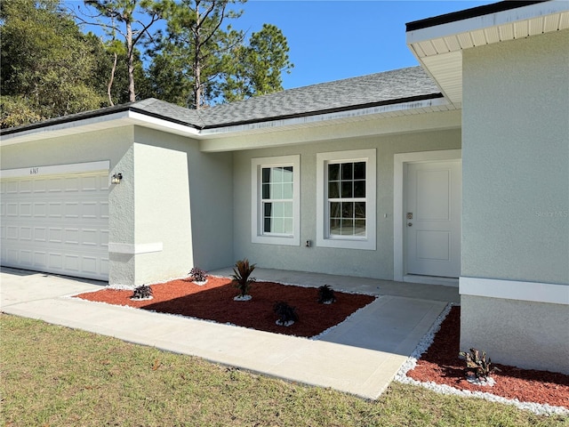 doorway to property featuring a garage