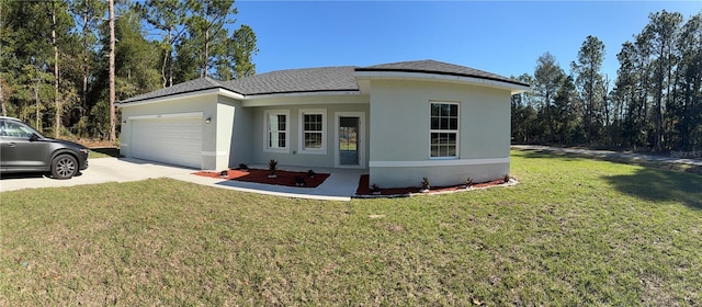 view of front of home with a front yard and a garage