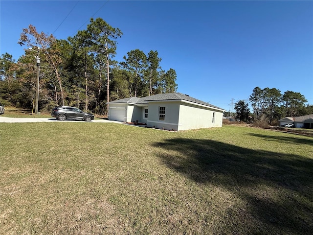 view of side of property featuring a yard and a garage