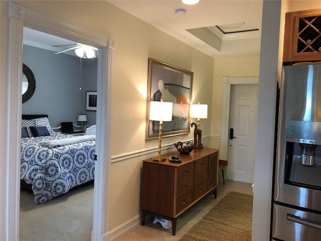 interior space featuring ceiling fan, stainless steel refrigerator with ice dispenser, and crown molding