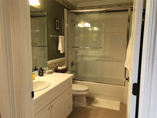 full bathroom with toilet, combined bath / shower with glass door, tile patterned floors, and vanity