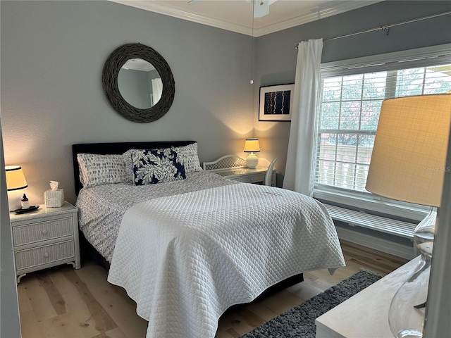 bedroom featuring crown molding and light wood-type flooring