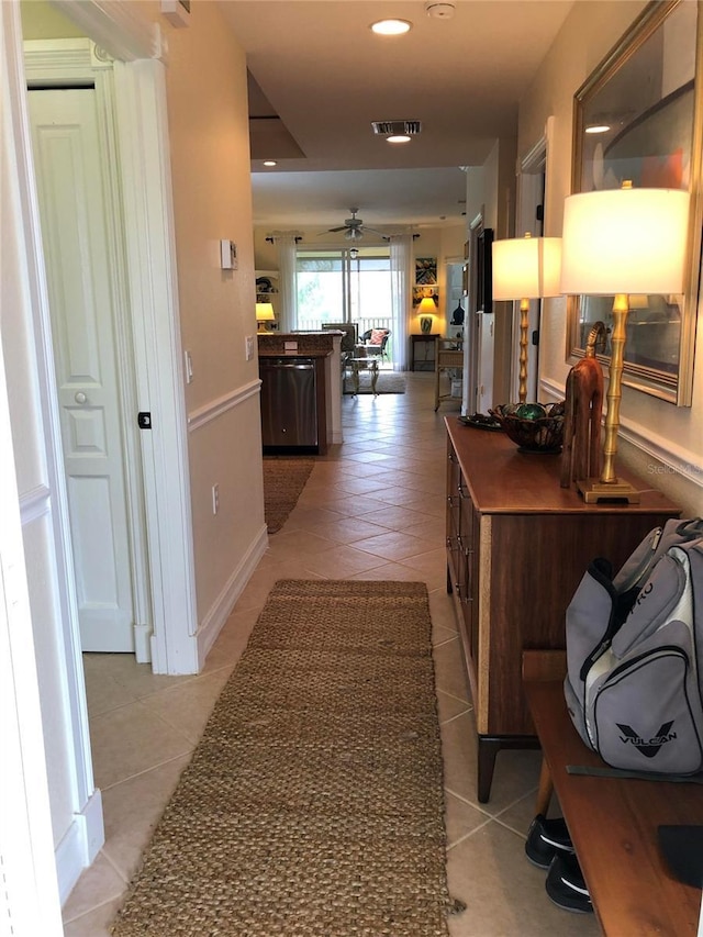 hallway featuring light tile patterned floors, visible vents, and recessed lighting