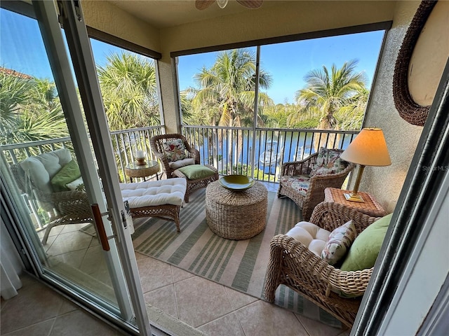 sunroom featuring a water view