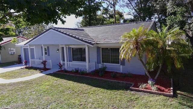 single story home with a porch and a front yard