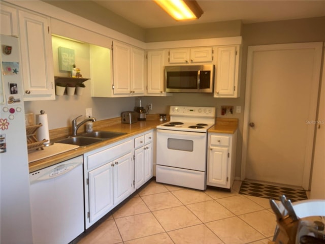 kitchen with white cabinetry, white appliances, sink, and light tile patterned floors