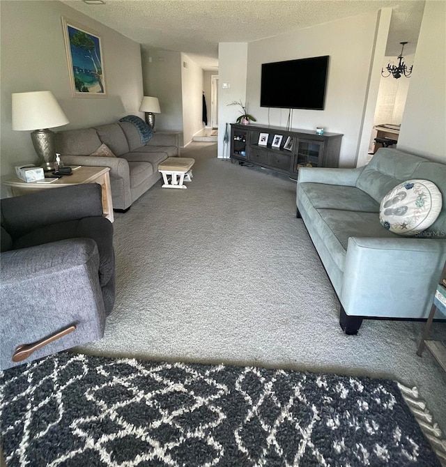 carpeted living room featuring a textured ceiling