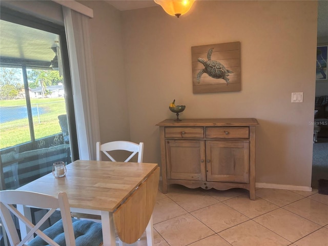 dining space featuring light tile patterned floors