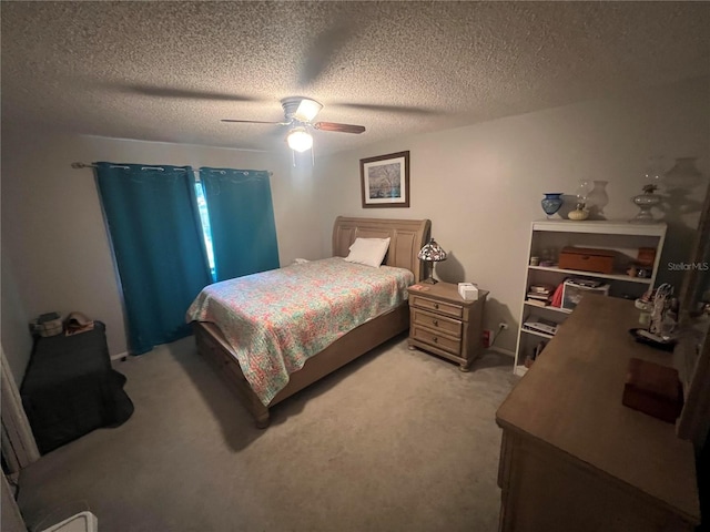 carpeted bedroom with a textured ceiling and ceiling fan