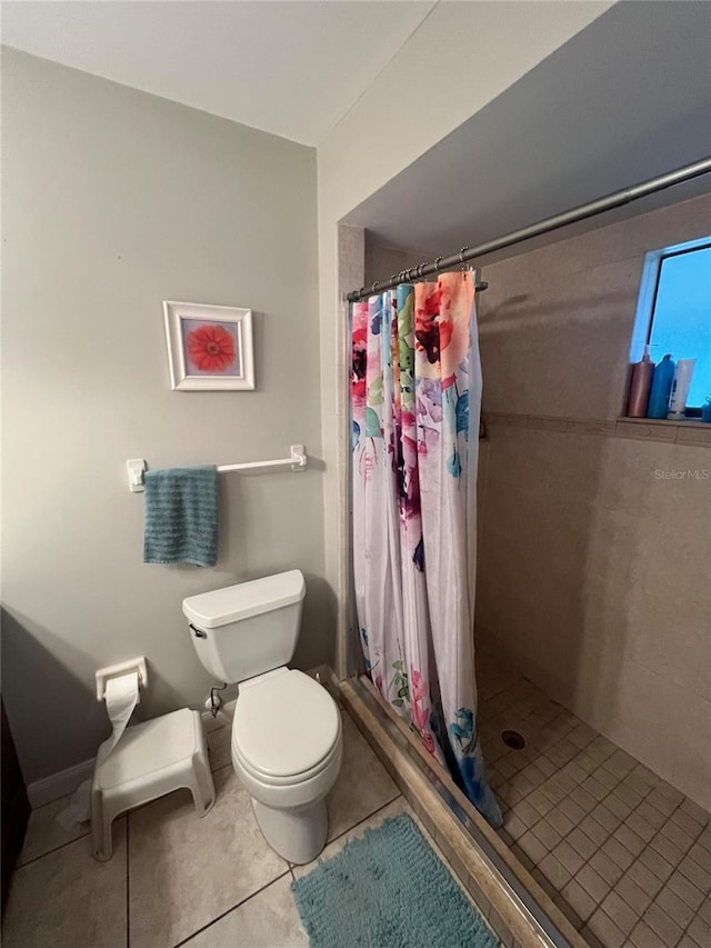 bathroom with curtained shower, tile patterned floors, and toilet