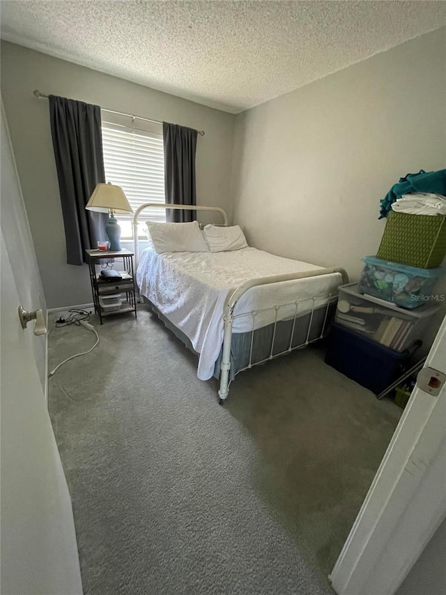 carpeted bedroom with a textured ceiling