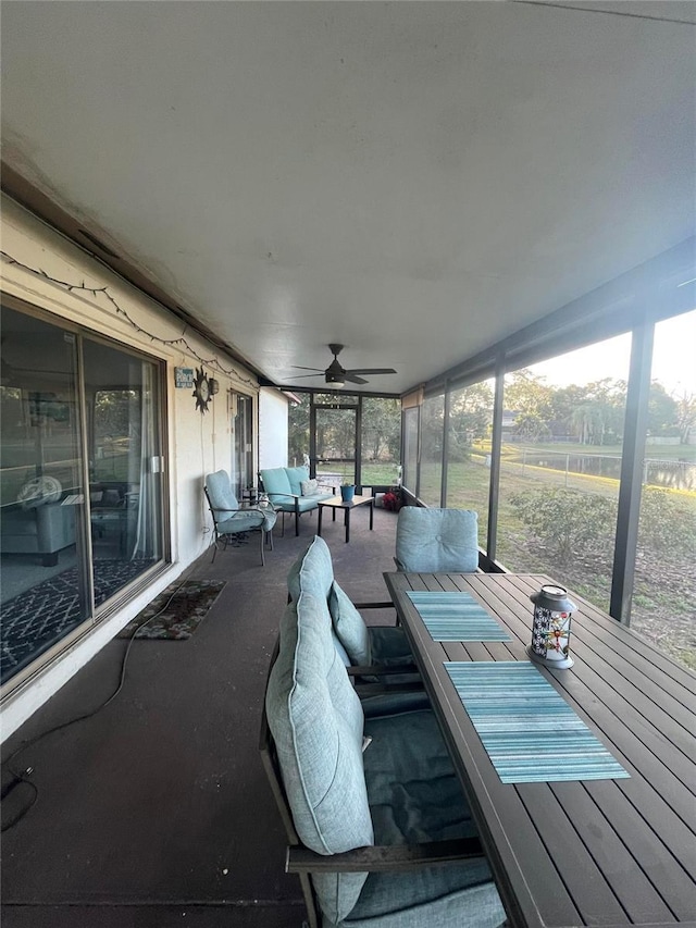 unfurnished sunroom featuring ceiling fan