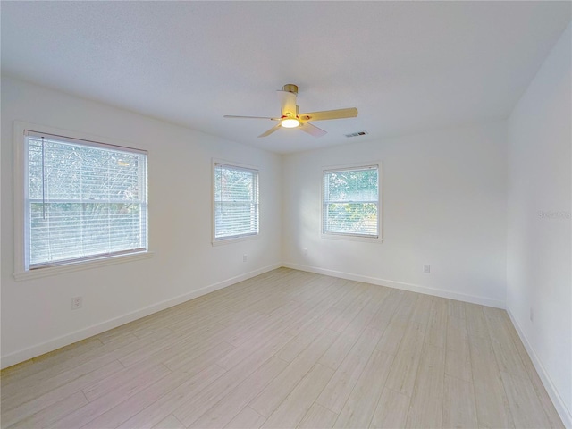 empty room featuring ceiling fan and light hardwood / wood-style flooring