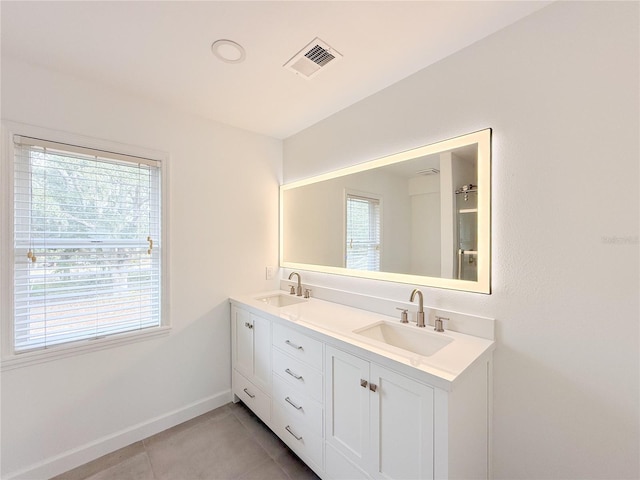 bathroom featuring tile patterned flooring and vanity