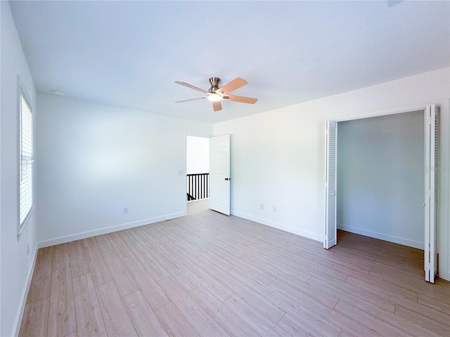 unfurnished room featuring ceiling fan and light hardwood / wood-style flooring