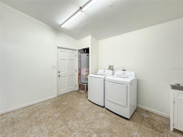 laundry area with gas water heater and washing machine and dryer