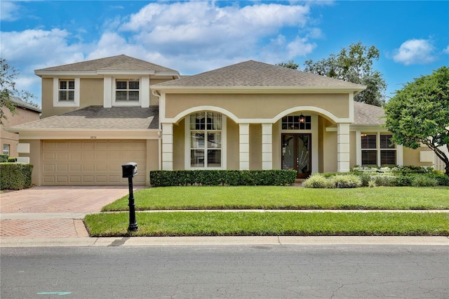 view of front facade featuring a garage and a front yard