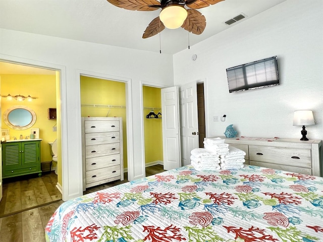 bedroom with sink, dark wood-type flooring, ceiling fan, and ensuite bathroom