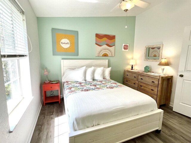 bedroom with vaulted ceiling and dark hardwood / wood-style floors