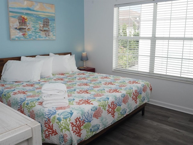 bedroom with dark hardwood / wood-style flooring