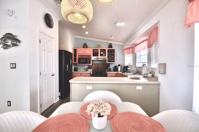 kitchen with lofted ceiling, kitchen peninsula, sink, and black appliances