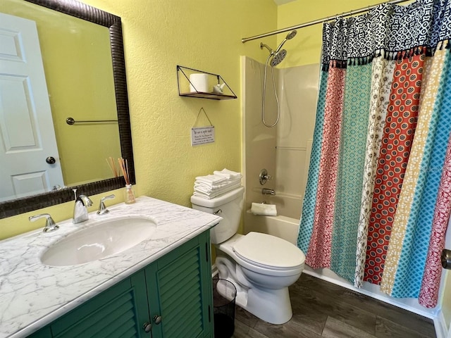 full bathroom with vanity, toilet, hardwood / wood-style floors, and shower / bath combo