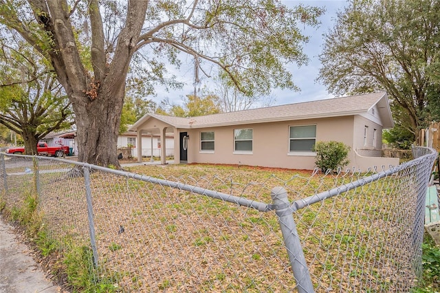 ranch-style home featuring fence private yard and stucco siding