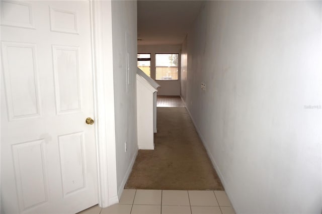 hallway featuring light colored carpet