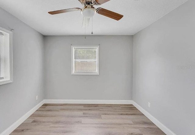 unfurnished room featuring light wood-type flooring and ceiling fan