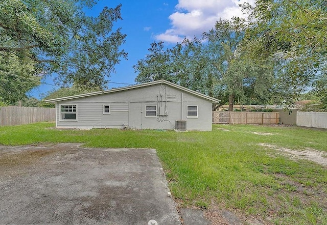 back of property with a patio area and a lawn