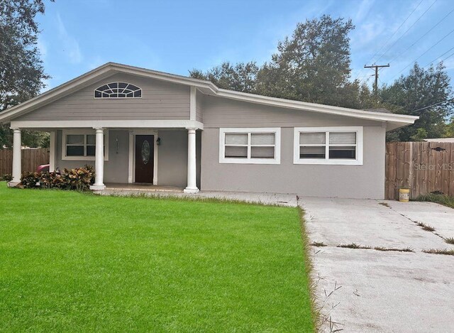 view of front facade with a front yard and a porch