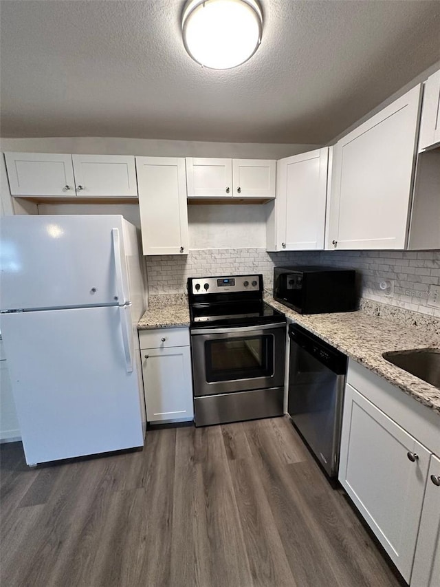 kitchen with backsplash, white cabinetry, dark hardwood / wood-style flooring, and stainless steel appliances