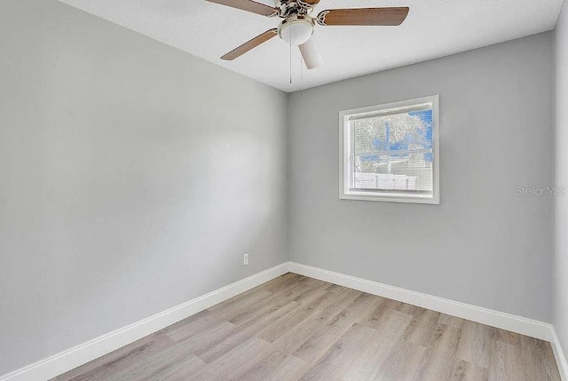 spare room featuring light wood-type flooring and ceiling fan