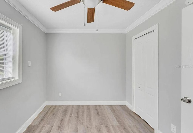 spare room featuring ceiling fan, light hardwood / wood-style flooring, and crown molding