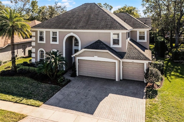 view of front facade featuring a front lawn and a garage