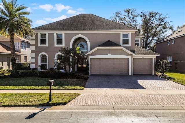 view of front of property featuring a front yard and a garage