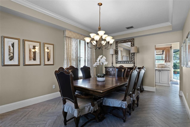 dining area with dark parquet floors, a notable chandelier, and crown molding