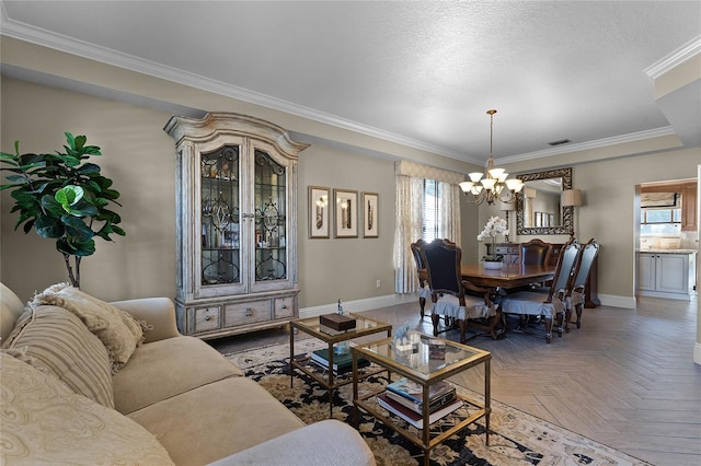 living room with a textured ceiling, ornamental molding, parquet floors, and a chandelier