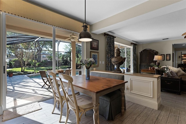 dining room with ceiling fan, plenty of natural light, and ornamental molding