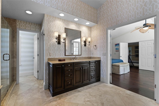 bathroom with ceiling fan, walk in shower, and vanity