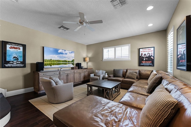 living room with a textured ceiling, ceiling fan, and light hardwood / wood-style flooring