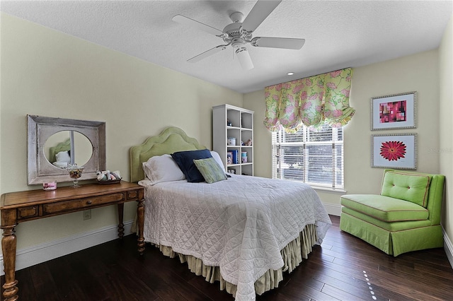 bedroom featuring ceiling fan, dark wood-type flooring, and a textured ceiling