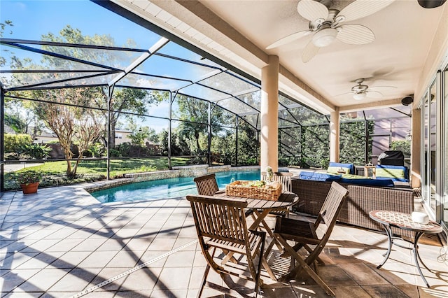 view of patio featuring glass enclosure, outdoor lounge area, and ceiling fan