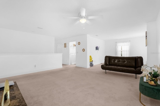 unfurnished room featuring ceiling fan and light colored carpet