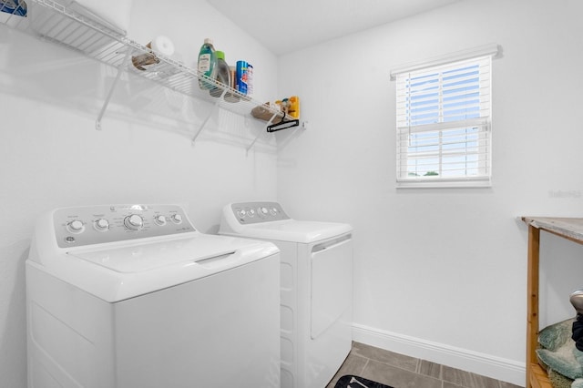 laundry room with washing machine and dryer and tile patterned flooring