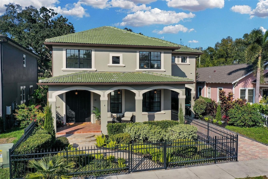 mediterranean / spanish house featuring a porch