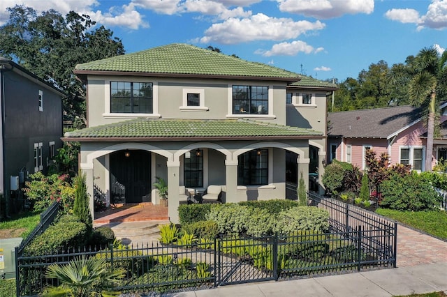 mediterranean / spanish house featuring a porch