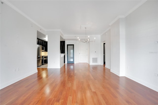 630 Vassar St Unit 2310, Orlando, FL 32804 - unfurnished living room with crown molding, hardwood / wood-style floors, and a notable chandelier