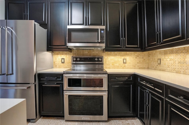 630 Vassar St Unit 2310, Orlando, FL 32804 - kitchen with appliances with stainless steel finishes and decorative backsplash